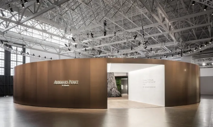 Round wood-clad Audemars Piguet exhibit pavilion in a warehouse